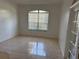 Well-lit room with neutral tile floors and window offering a view of the outside at 63 York Ct, Kissimmee, FL 34758