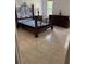 Bedroom featuring tile flooring, dark furniture, and a decorative wrought iron bed frame at 63 York Ct, Kissimmee, FL 34758