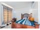 Bright bedroom with wood bed frame and striped bedding at 63 York Ct, Kissimmee, FL 34758