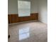 A bright, clean bedroom features tile flooring, wood paneling, and lots of natural light at 63 York Ct, Kissimmee, FL 34758
