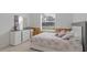 Cozy bedroom with light floral bedding, dresser, and an exterior view from the window at 63 York Ct, Kissimmee, FL 34758