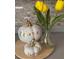 Close-up of a decorative fall themed display on the countertop with flowers and pumpkins at 63 York Ct, Kissimmee, FL 34758