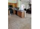 Spacious kitchen with stainless steel appliances, wooden cabinets, and an open dining area at 63 York Ct, Kissimmee, FL 34758