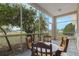 Screened porch with wooden table and chairs at 63 York Ct, Kissimmee, FL 34758