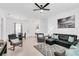 Comfortable living room featuring a sectional sofa, accent chairs, and tile floors at 7403 Velleux St, Reunion, FL 34747