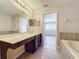 Main bathroom with double vanity and access to bedroom at 812 Park Grove Ct, Orlando, FL 32828