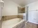 Bathroom with soaking tub, shower, and tile flooring at 812 Park Grove Ct, Orlando, FL 32828