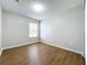 Bright bedroom with wood-look floors and a window at 812 Park Grove Ct, Orlando, FL 32828