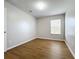 Bright bedroom with wood-look floors and a window at 812 Park Grove Ct, Orlando, FL 32828