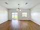 Dining room with hardwood floors, chandelier, and lake view at 812 Park Grove Ct, Orlando, FL 32828