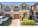 Two-story townhome with attached garage and landscaped front yard at 812 Park Grove Ct, Orlando, FL 32828