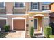 Two-story townhome with attached garage and landscaped front yard at 812 Park Grove Ct, Orlando, FL 32828