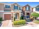 Two-story townhome with attached garage and landscaped front yard at 812 Park Grove Ct, Orlando, FL 32828
