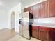 Kitchen with stainless steel refrigerator and dark wood cabinets at 812 Park Grove Ct, Orlando, FL 32828