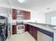 Modern kitchen with stainless steel appliances and dark wood cabinets at 812 Park Grove Ct, Orlando, FL 32828