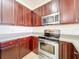 Kitchen with stainless steel appliances and wood cabinets at 812 Park Grove Ct, Orlando, FL 32828