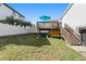Backyard oasis with deck, kayaks, and grassy area at 830 Garfish Ave, New Smyrna Beach, FL 32169