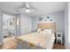 Guest bedroom with a queen bed, en-suite bathroom, and coastal decor at 830 Garfish Ave, New Smyrna Beach, FL 32169