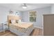 Bedroom with a queen bed, coastal decor and wood floors at 830 Garfish Ave, New Smyrna Beach, FL 32169