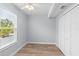 Small bedroom with white built-in closets and wood floors at 830 Garfish Ave, New Smyrna Beach, FL 32169