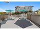 Spacious deck with seating, dining area, and grill at 830 Garfish Ave, New Smyrna Beach, FL 32169