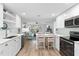 Open concept kitchen with stainless steel appliances and breakfast bar at 830 Garfish Ave, New Smyrna Beach, FL 32169