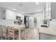 Modern white kitchen with breakfast bar and stainless steel appliances at 830 Garfish Ave, New Smyrna Beach, FL 32169