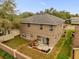 Two story house with backyard patio, small garden, and grassy area at 8567 Baywood Vista Dr, Orlando, FL 32810