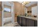 Double vanity bathroom with granite countertops at 8567 Baywood Vista Dr, Orlando, FL 32810