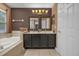 Bathroom with double vanity, granite countertop and large bathtub at 8567 Baywood Vista Dr, Orlando, FL 32810