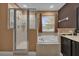 Bathroom with shower, bathtub and granite countertop at 8567 Baywood Vista Dr, Orlando, FL 32810