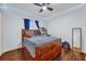 Bedroom featuring a double bed, ceiling fan, and wood floors at 8567 Baywood Vista Dr, Orlando, FL 32810