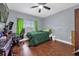 Bright bedroom with a double bed, ceiling fan, and wood floors at 8567 Baywood Vista Dr, Orlando, FL 32810