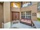 Front entry with double doors, a wicker couch, and a side table at 8567 Baywood Vista Dr, Orlando, FL 32810