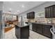 Open concept kitchen features dark cabinetry and an island at 8567 Baywood Vista Dr, Orlando, FL 32810