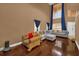 Living room with hardwood floors, sectional sofa, and large windows at 8567 Baywood Vista Dr, Orlando, FL 32810
