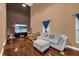 Spacious living room with hardwood floors, sectional sofa, and high ceilings at 8567 Baywood Vista Dr, Orlando, FL 32810