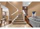 Elegant staircase with carpeted steps and wood flooring at 8567 Baywood Vista Dr, Orlando, FL 32810