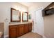 Double vanity bathroom with granite countertop, large mirrors, and a tiled floor at 863 Strathmore Dr, Orlando, FL 32803