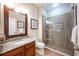 Bathroom with granite vanity, large mirror, and a glass-enclosed shower at 863 Strathmore Dr, Orlando, FL 32803
