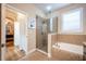 Spa-like bathroom with a walk-in shower, soaking tub, and access to bedroom at 863 Strathmore Dr, Orlando, FL 32803