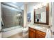 Bathroom features granite vanity, a bathtub, and a sliding glass shower door at 863 Strathmore Dr, Orlando, FL 32803
