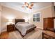 Comfortable bedroom with a queen-size bed, wooden furniture, and hardwood floors at 863 Strathmore Dr, Orlando, FL 32803