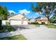 House exterior with a three-car garage and landscaped yard at 863 Strathmore Dr, Orlando, FL 32803