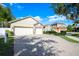 Two-story house with stone accents and a three-car garage at 863 Strathmore Dr, Orlando, FL 32803