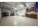 Spacious garage with overhead storage, epoxy flooring, and plenty of room for cars and storage at 863 Strathmore Dr, Orlando, FL 32803