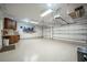 Large garage with overhead storage, epoxy flooring, and a workshop area at 863 Strathmore Dr, Orlando, FL 32803