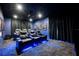 State-of-the-art home theater with reclining seats and ambient blue lighting at 863 Strathmore Dr, Orlando, FL 32803