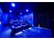 State-of-the-art home theater with reclining seats and ambient blue lighting at 863 Strathmore Dr, Orlando, FL 32803