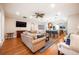 Spacious living room features hardwood floors, comfortable seating, and a view into the kitchen at 863 Strathmore Dr, Orlando, FL 32803